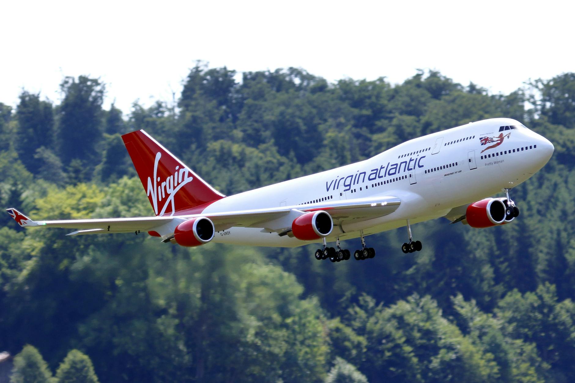 Best Airlines to Fly Business Class to the UK from the USA (2026 Guide) 8 large radio controlled model of a commercial airplane flying against trees Best Airlines to Fly Business Class to the UK from the USA (2026 Guide)