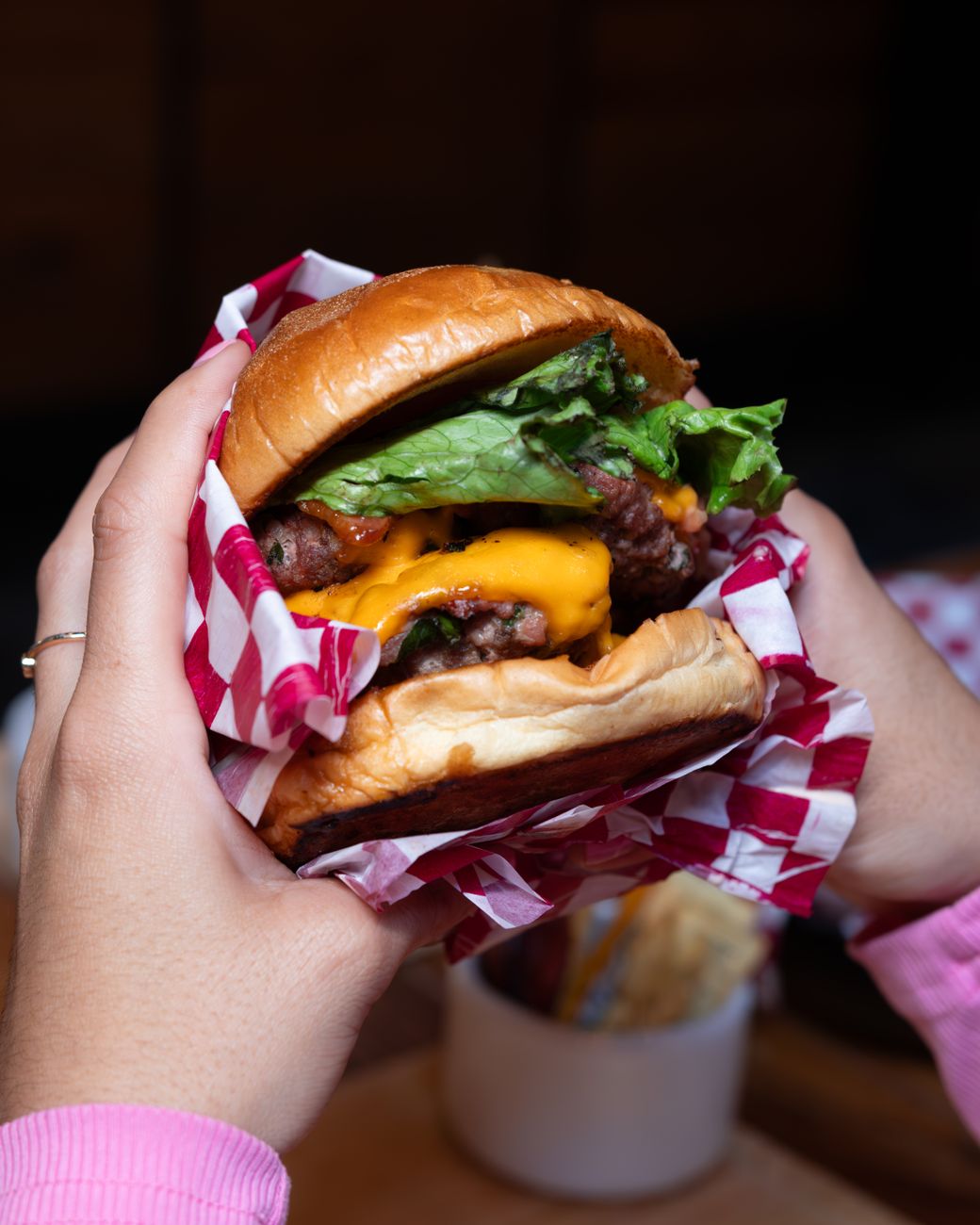 a person holding a burger Rotational Grazing: Building Healthier Soil, Livestock, and Food